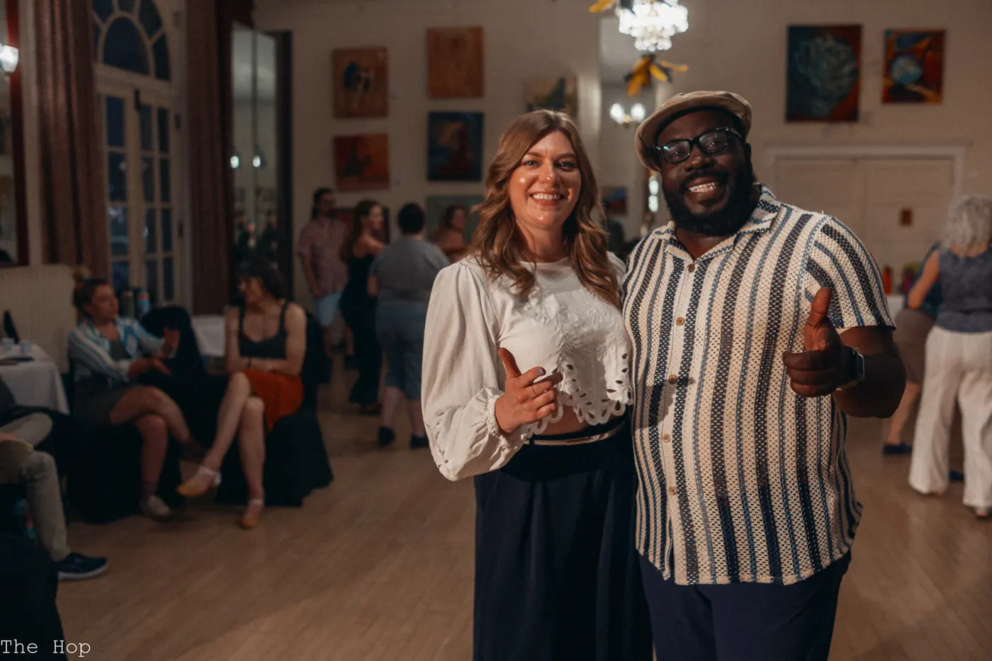 Two dancers smiling after a song